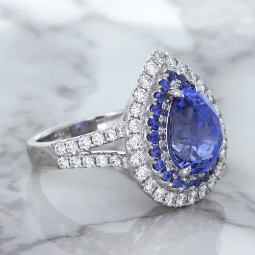 6.08ct Pear Shaped Blue Sapphire Ring with Sapphire and Diamond halo in 18K White Gold