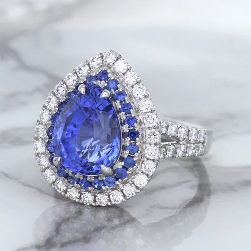 6.08ct Pear Shaped Blue Sapphire Ring with Sapphire and Diamond halo in 18K White Gold