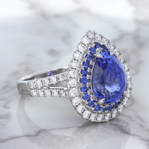 6.08ct Pear Shaped Blue Sapphire Ring with Sapphire and Diamond halo in 18K White Gold