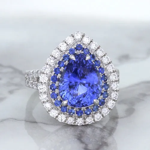 6.08ct Pear Shaped Blue Sapphire Ring with Sapphire and Diamond halo in 18K White Gold