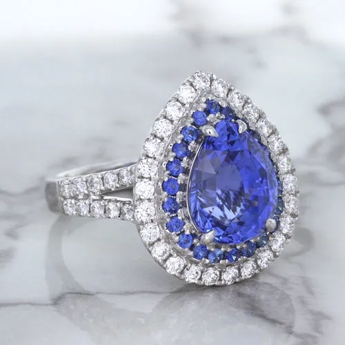 6.08ct Pear Shaped Blue Sapphire Ring with Sapphire and Diamond halo in 18K White Gold