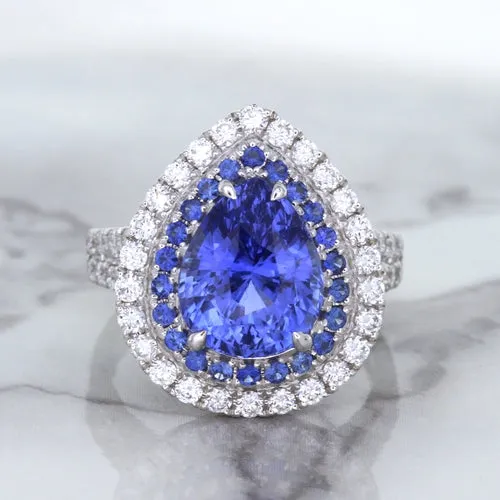 6.08ct Pear Shaped Blue Sapphire Ring with Sapphire and Diamond halo in 18K White Gold