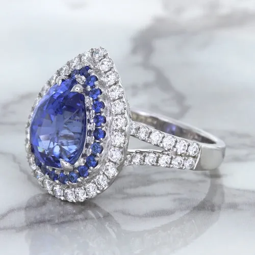 6.08ct Pear Shaped Blue Sapphire Ring with Sapphire and Diamond halo in 18K White Gold