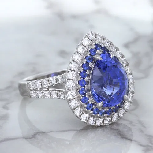 6.08ct Pear Shaped Blue Sapphire Ring with Sapphire and Diamond halo in 18K White Gold