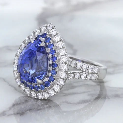 6.08ct Pear Shaped Blue Sapphire Ring with Sapphire and Diamond halo in 18K White Gold