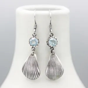 Blue topaz earrings in silver bezel setting with sterling silver shell shape on silver hooks style