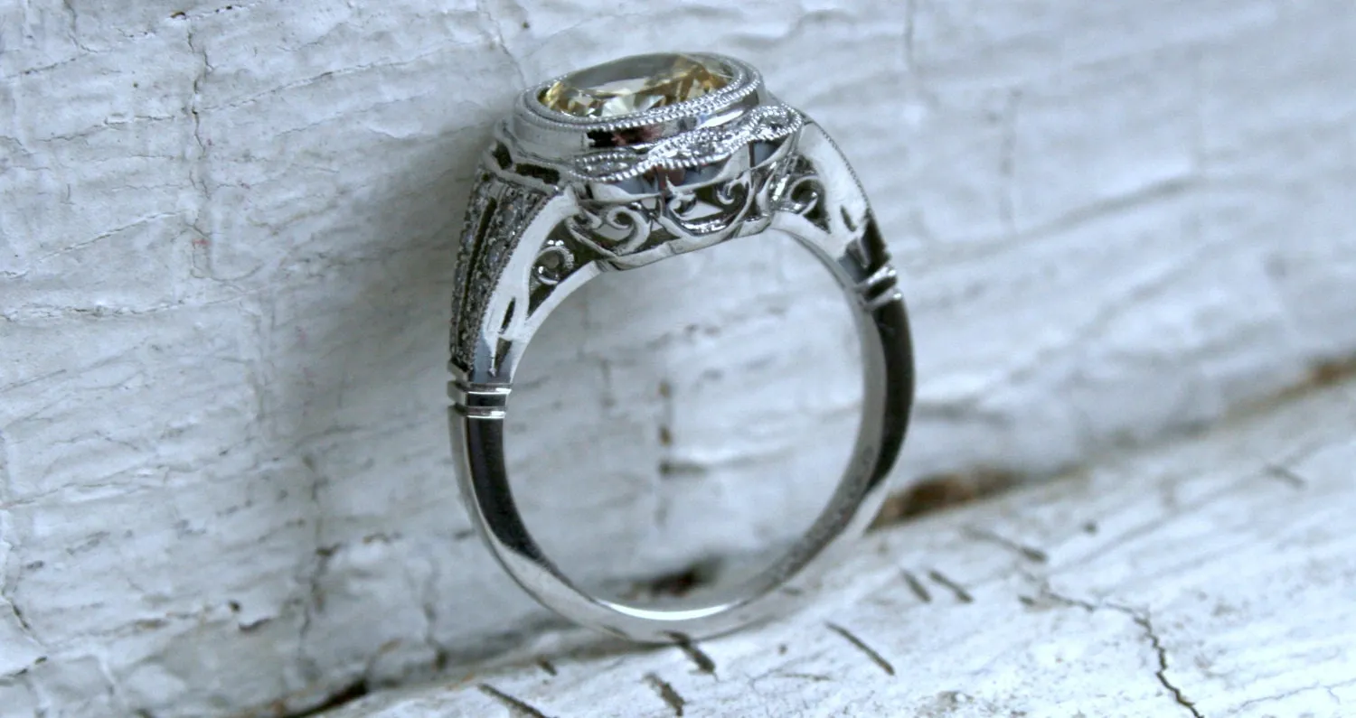 Natural Yellow Sapphire and Diamond Halo Engagement Ring in Platinum.