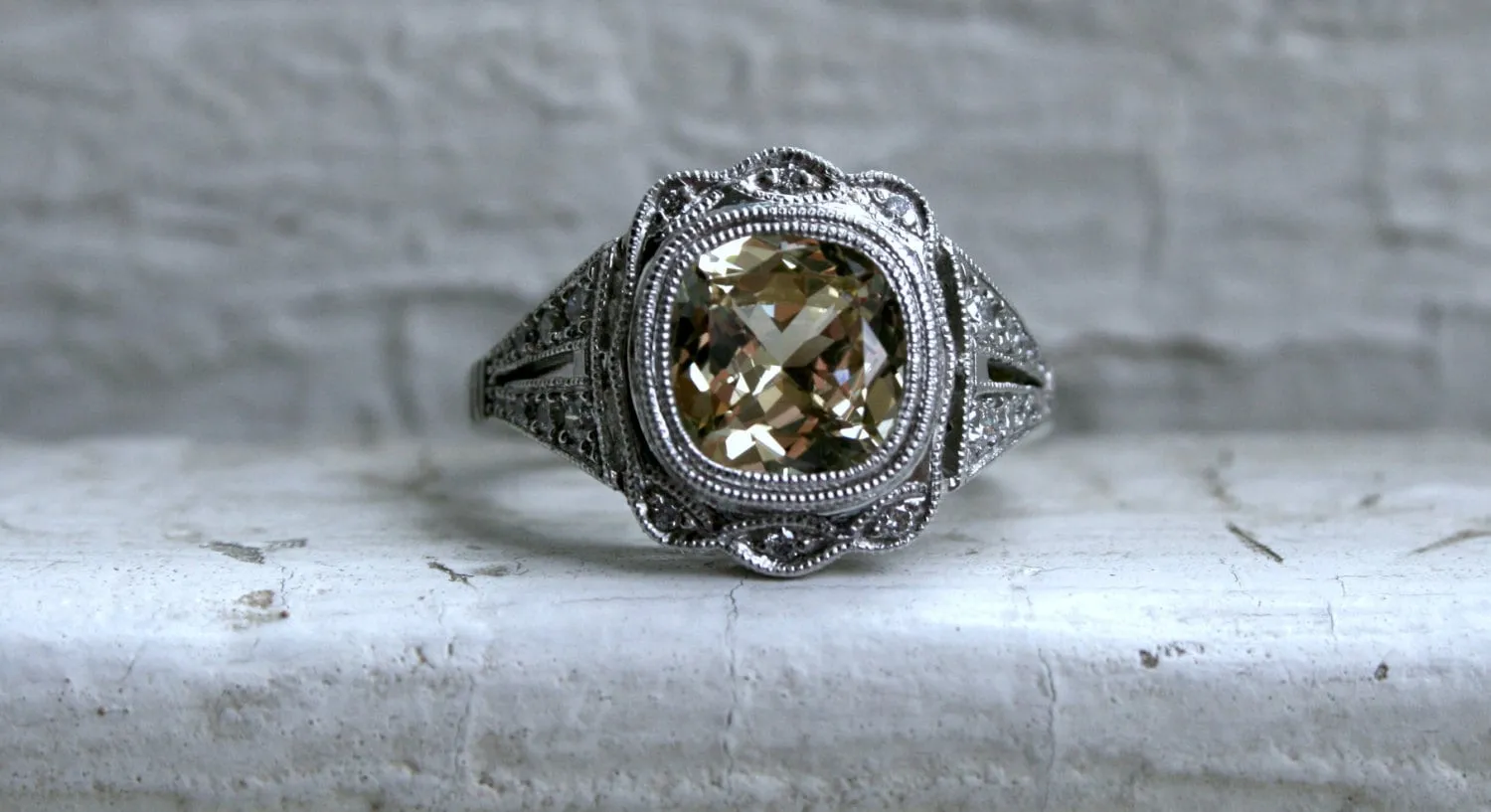 Natural Yellow Sapphire and Diamond Halo Engagement Ring in Platinum.