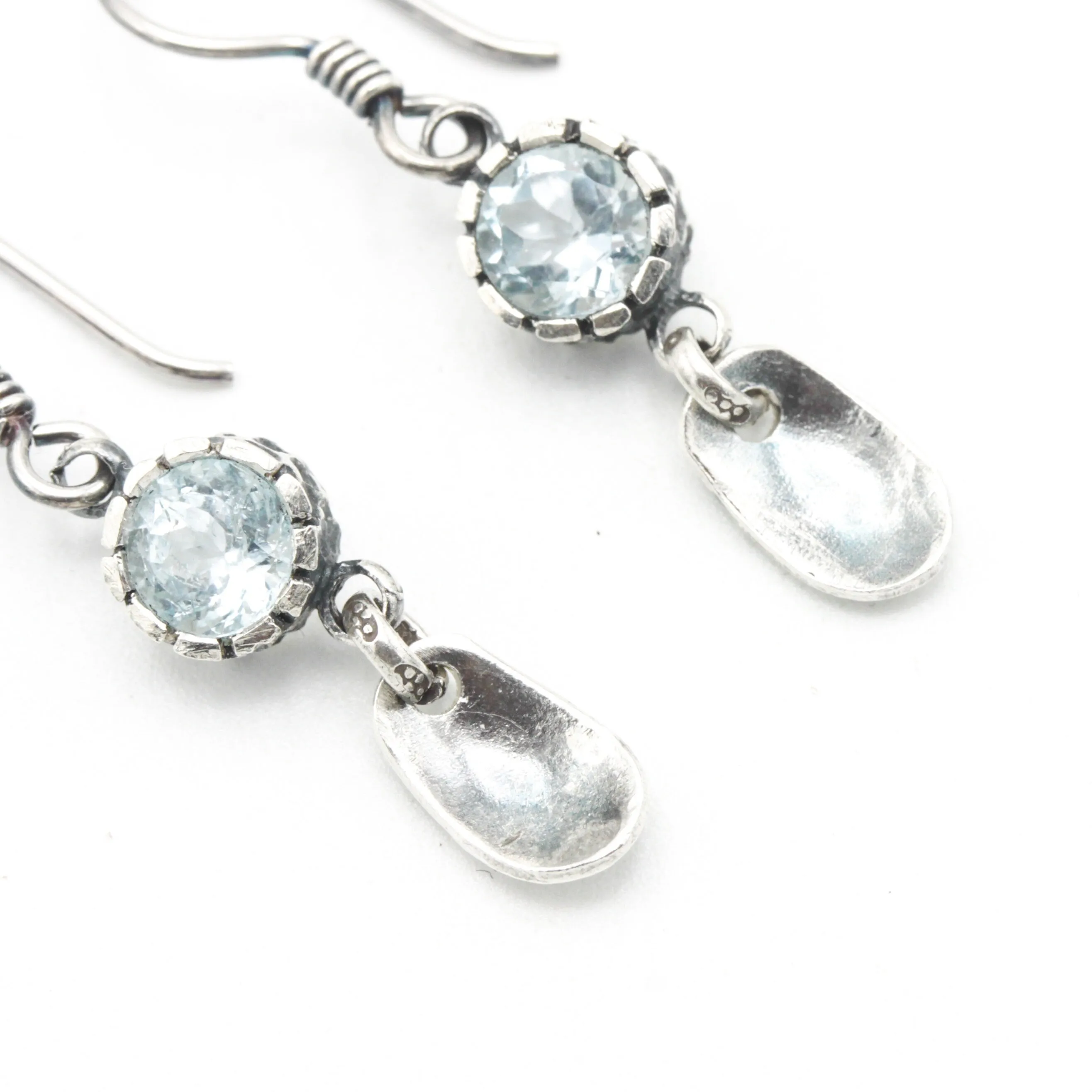 Round blue topaz earrings in silver bezel setting with silver leaf on sterling silver hooks style