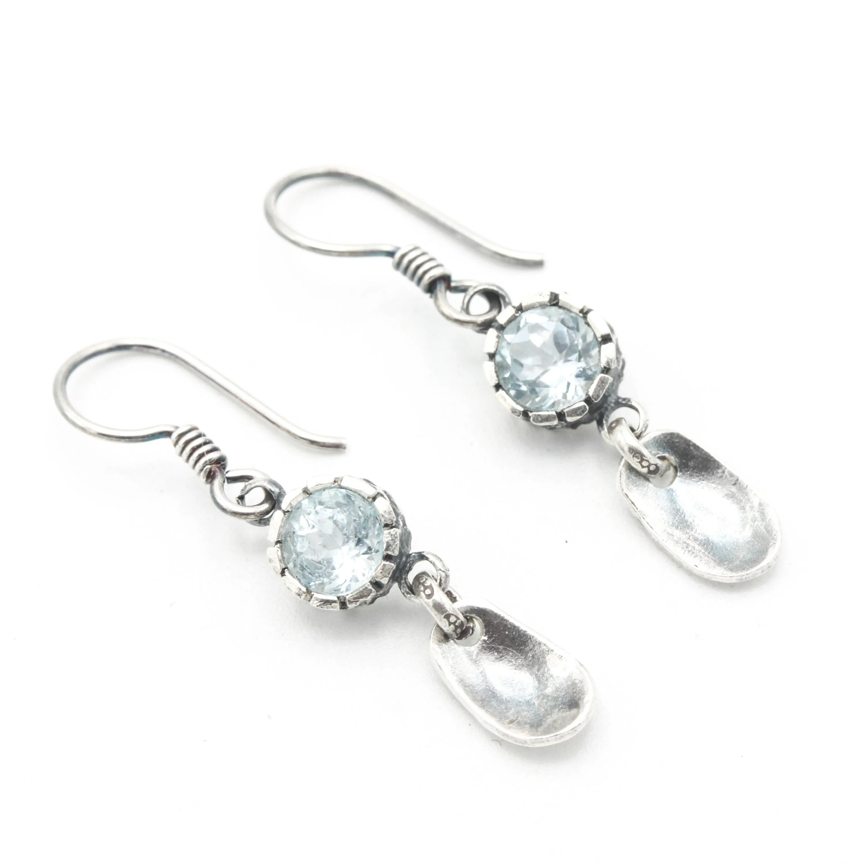 Round blue topaz earrings in silver bezel setting with silver leaf on sterling silver hooks style